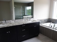 Master bathroom with double vanity and granite countertop