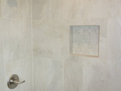 Ceramic tile with designer details in main bathroom
