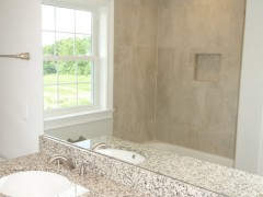 Ceramic tiled walls in main bathroom