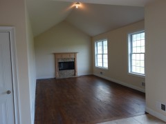 Family room with cathedral ceiling and wood burning fireplace