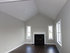 Family room featuring premier oak hardwood floors (available in multiple stain colors), and standard gas fireplace.