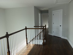 Upstairs landing with full-size laundry room, many railing options are available in wood and metal.